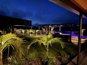 NIght view of garden and pool in courtyard