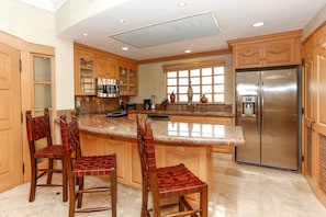 Spacious kitchen with granite countertops and stainless steel appliances