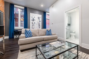 Open concept living, kitchen, and dining area with plenty of seating for you and your guests. 55” Samsung Smart 4K TV with streaming options and DIRECTV Entertainment. Dining table for two, and a sofa that converts to a full-size sleeper!