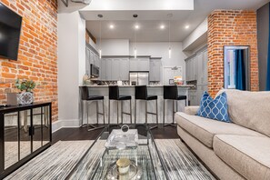 Open concept living, kitchen, and dining area with plenty of seating for you and your guests. 55” Samsung Smart 4K TV with streaming options and DIRECTV Entertainment. Dining table for two, and a sofa that converts to a full-size sleeper!