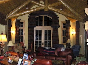 Great room with log beams and three distinct seating areas