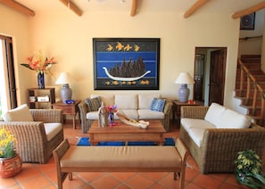 View of the living room, door to bedroom 1 and stairs to 2nd floor.