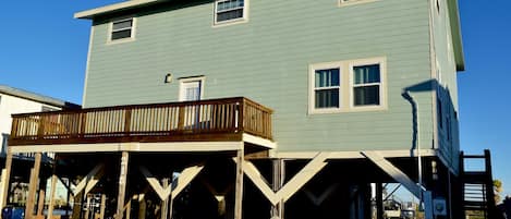 View of house from street, showing parking and grassy yard