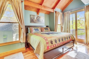 Master bedroom no. 1, cathedral ceiling, king size bed and walk out to the deck