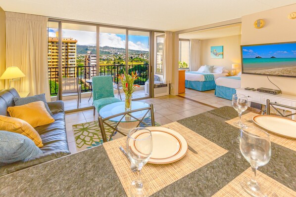 1 bedroom condo with beautiful mountain and city views, living room with open kitchen, window AC and reclining sleeper sofa, bedroom with 1 queen size and 1 full size bed.