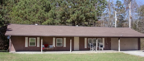 Large full length porch, with open yardage on three sides of the home