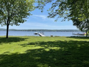 Sweeping 115' lakefront, 75' dock with chairs and large yard great for games