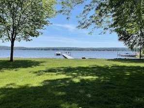 Sweeping 115' lakefront, 75' dock with chairs and large yard great for games