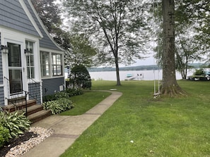 Sun porch with beautiful lake views, side yard with inviting tree swing