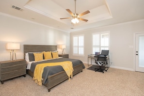 Spacious main bedroom with desk and office chair in case you need to work remotely. Shutters throughout the house with views of lake from the desk. Backdoor leads to back porch.