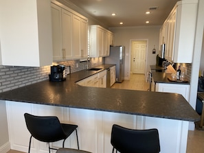 Remodeled kitchen with plenty of counter space for your cooking needs.