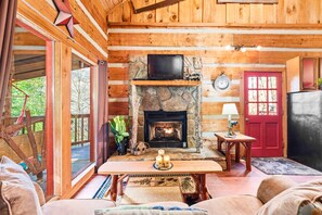 Living room with fireplace and vaulted ceilings