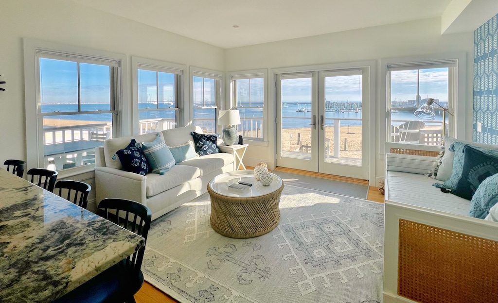 A bright and spacious living room looks out on gorgeous beach views in Provincetown, Massachusetts..