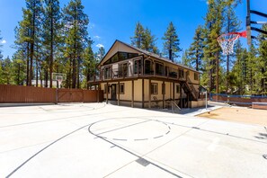 Basket ball court and volley ball net on back side of house. Completely fenced off.