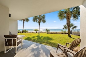 Private ground level patio with a beach view