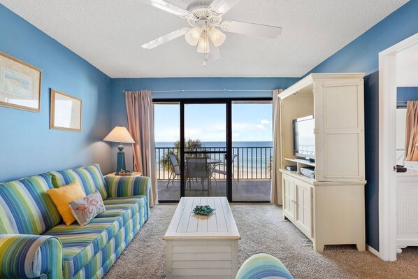Living room with flat screen tv and plenty of seating.