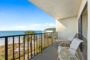 Balcony with lounge chairs and a gulf view.