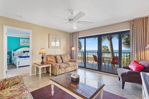 Living room area with sleeper sofa and gulf view.