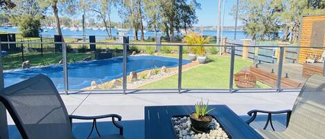 outdoor sitting area overlooking pool and lake
