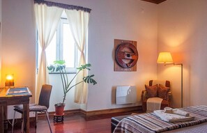 A traditional oxcart wheel adorns the expansive, light-filled master bedroom.