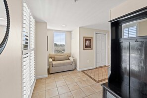 As you enter the property there is a single size pull out bed for extra overnight guest. Linen provided. Enter the hallway to the kitchen.