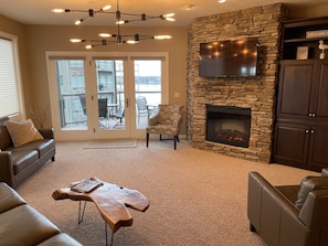 Living room with beautiful views of the lake, Smart TV, & electric fireplace