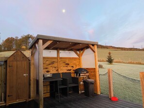 Outside heated cupboard for wet coats and boots, outside seating and eating furniture and wind and rain protection
