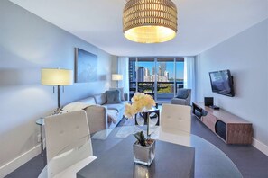 Living room, balcony access, Tv, dining area
