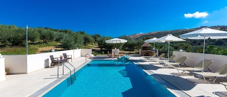 Pool area with umbrellas and sun beds.