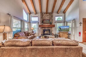 Relax in style in the spacious living room, where a comfy couch, inviting fireplace, and TV create the perfect atmosphere for downtime and cozy evenings