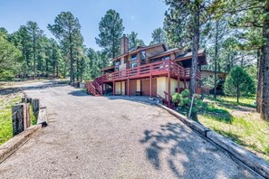 Discover the charming cabin facade, conveniently located beside the road, offering easy access and a welcoming entrance to your peaceful retreat