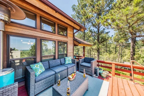Enjoy the outdoors on the patio, complete with a cozy couch and table, offering stunning nature views — the perfect spot to relax and take in the scenery!