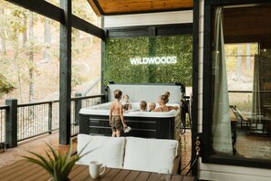 A spacious hot tub offers the perfect place to unwind with family and friends. This secluded outdoor spa provides a relaxing escape, surrounded by nature. Enjoy a luxury retreat with modern comforts and a peaceful setting designed for relaxation.