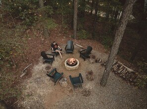 Gather around a crackling fire pit, surrounded by comfortable Adirondack chairs in a scenic woodland setting. Perfect for stargazing, roasting marshmallows, and storytelling, this private outdoor retreat creates the ideal ambiance for cozy, memorable night