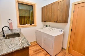 Laundry room with sink off of garage