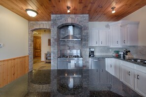 Gas range, two ovens and hooded vent.