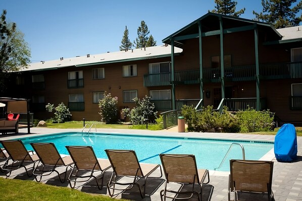 Large heated swimming pool and poolside loungers
