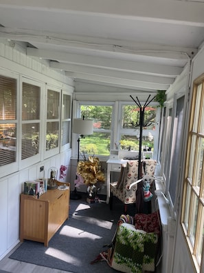 large enclosed porch with dedicated work area separate from rest of cottage
