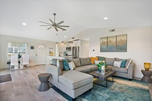 Masterful living room with large couch for spreading out and reclining! Ocean views from the windows and a big screen Smart TV with streaming apps and basic cable!