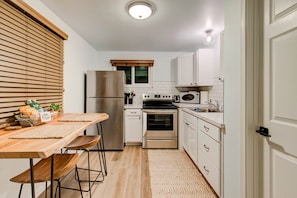 A fully stocked kitchen with plenty of utensils, dishes & basic ingredients