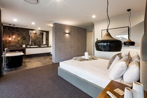 The primary suite is a luxe retreat with a queen bed and open-air ensuite.