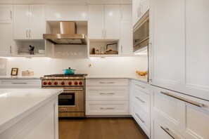 Fully Equipped Kitchen with Stainless Steel Appliances and Stone Counters