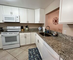 Entrance into the fully equipped kitchen right at the front of t - Entrance into the fully equipped kitchen right at the front of the condo.