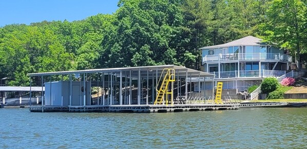 Beautiful house with large dock with dive platform and wet steps ladder.