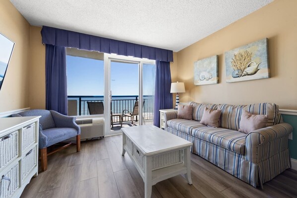 Relax in style and comfort in this spacious living area with panoramic ocean views!