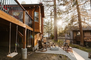 Sway into relaxation with our cabin's charming wooden swings, tucked under the deck.
