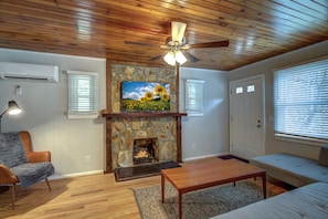 The upstairs living room is set for relaxing: reading nook, TV and fireplace.