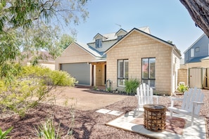 Enjoy the spacious front yard with comfortable seating, ideal for soaking up the sun or sipping your morning coffee.