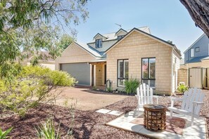 Enjoy the spacious front yard with comfortable seating, ideal for soaking up the sun or sipping your morning coffee.