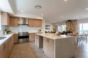 Cook up a storm in the fully-equipped kitchen with a premium SMEG oven, then gather around the large dining table for memorable meals.